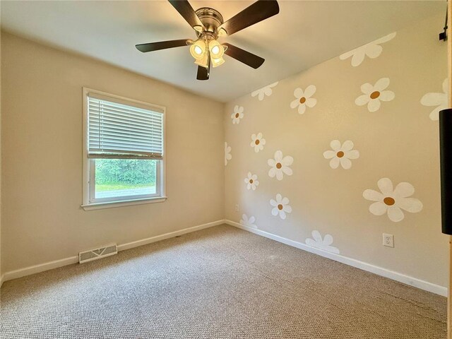 7729 Humbert Rd, Godfrey, IL 62035 - carpeted spare room with baseboards and ceiling fan