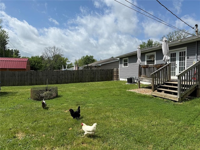 7729 Humbert Rd, Godfrey, IL 62035 - view of yard with french doors, a wooden deck, and central AC