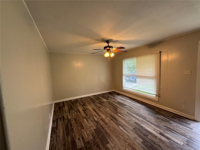124 Saint James Ln, Cahokia, IL 62206 - spare room with dark wood finished floors, a ceiling fan, and baseboards