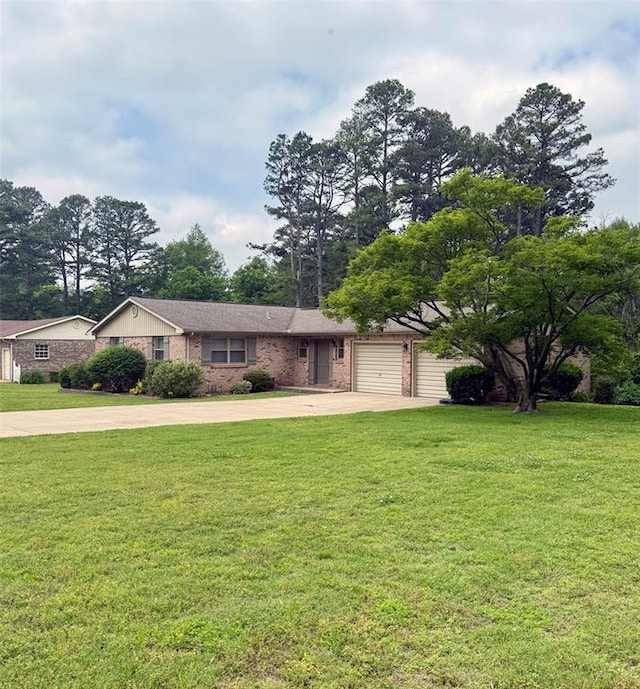 11181 Shady Ln, Dexter, MO 63841 - view of front of home with concrete driveway, a front lawn, brick siding, and an attached garage