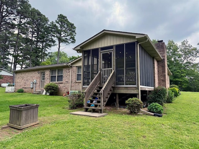 11181 Shady Ln, Dexter, MO 63841 - rear view of property featuring a chimney, a sunroom, a lawn, and entry steps