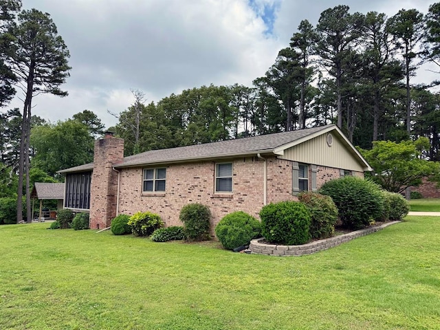 11181 Shady Ln, Dexter, MO 63841 - view of property exterior with brick siding, a chimney, and a yard