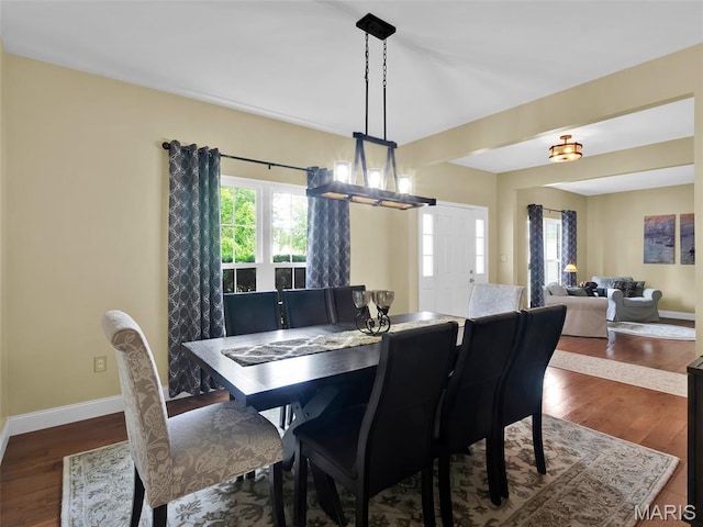 1165 Nooning Tree Dr, Chesterfield, MO 63017 - dining area with baseboards, a chandelier, and dark wood-style flooring