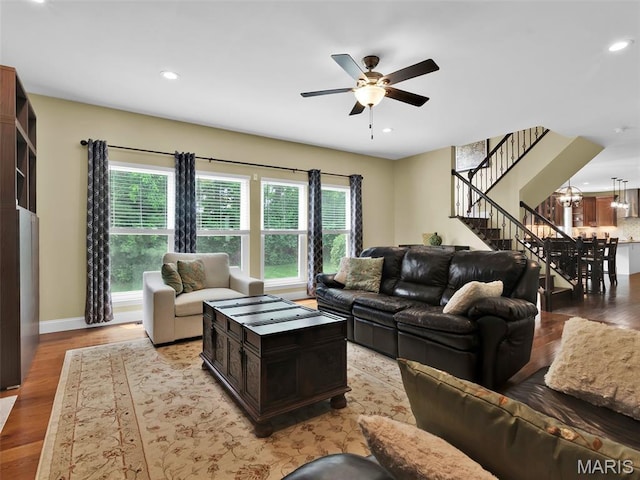 1165 Nooning Tree Dr, Chesterfield, MO 63017 - living room featuring stairs, light wood-type flooring, ceiling fan, recessed lighting, and a chandelier