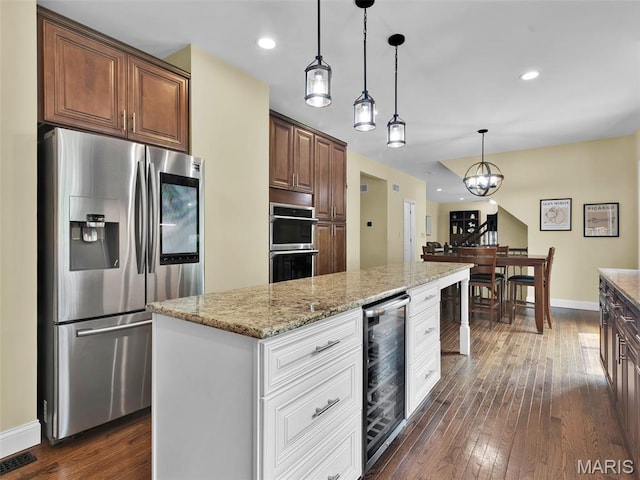 1165 Nooning Tree Dr, Chesterfield, MO 63017 - kitchen featuring appliances with stainless steel finishes, wine cooler, baseboards, dark wood finished floors, and recessed lighting