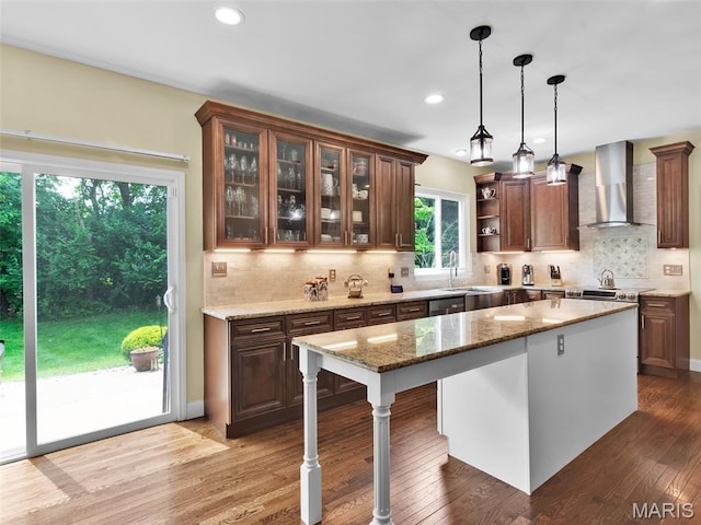 1165 Nooning Tree Dr, Chesterfield, MO 63017 - kitchen featuring wall chimney exhaust hood, wood finished floors, open shelves, backsplash, and a sink
