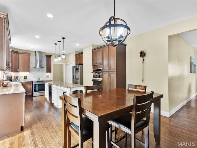 1165 Nooning Tree Dr, Chesterfield, MO 63017 - dining space with a chandelier, dark wood-style floors, recessed lighting, baseboards, and beverage cooler