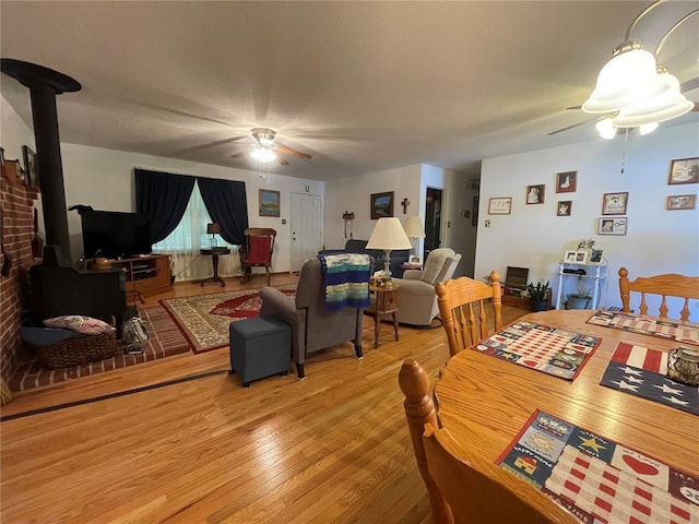 95 W Lakeview Dr, De Soto, MO 63020 - dining room with ceiling fan, a wood stove, and light wood-type flooring