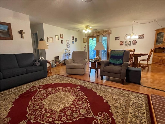 95 W Lakeview Dr, De Soto, MO 63020 - living room with wood finished floors, a ceiling fan, and a chandelier