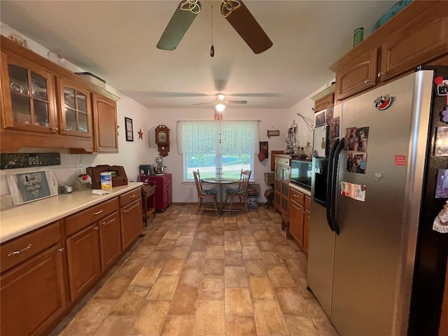 95 W Lakeview Dr, De Soto, MO 63020 - kitchen with stainless steel fridge, a ceiling fan, brown cabinets, light countertops, and glass insert cabinets