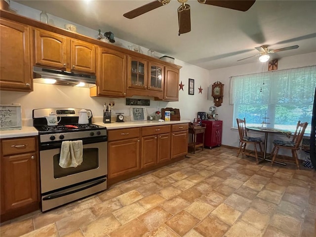95 W Lakeview Dr, De Soto, MO 63020 - kitchen featuring gas stove, under cabinet range hood, a ceiling fan, and brown cabinetry