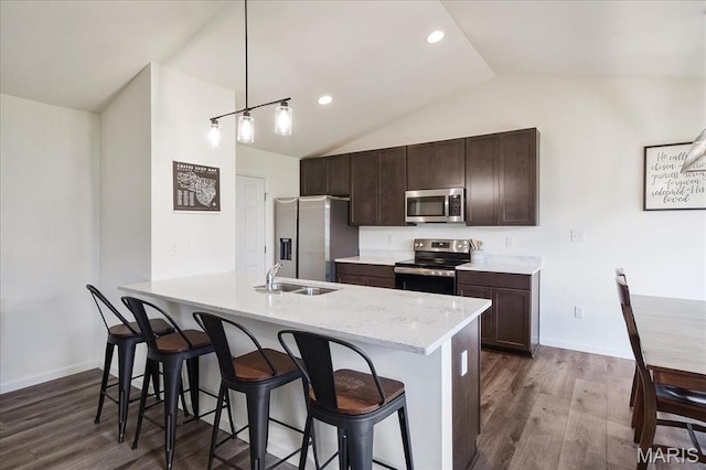 800 Boulder Crest Ct, Eureka, MO 63025 - kitchen with stainless steel appliances, vaulted ceiling, dark wood-style flooring, dark brown cabinets, and a breakfast bar