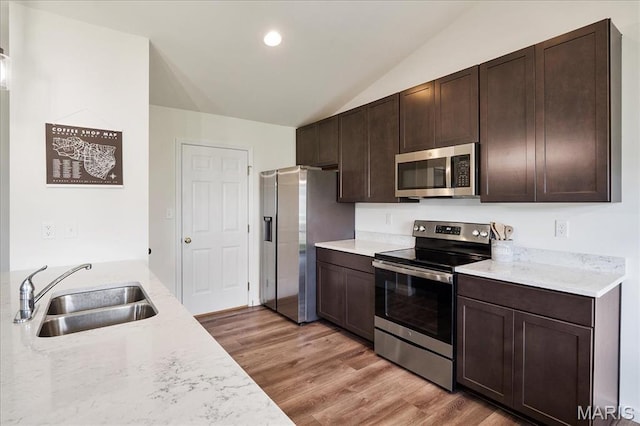 800 Boulder Crest Ct, Eureka, MO 63025 - kitchen featuring appliances with stainless steel finishes, a sink, lofted ceiling, light countertops, and recessed lighting