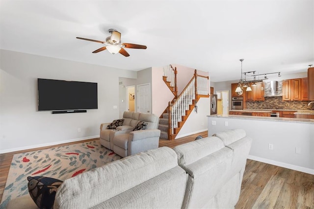 3912 Jacobs Lndg, Saint Charles, MO 63304 - living room with wood finished floors, a ceiling fan, stairs, and baseboards
