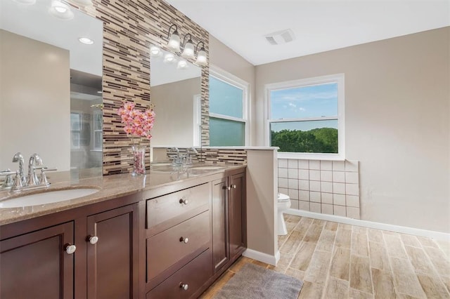 3912 Jacobs Lndg, Saint Charles, MO 63304 - full bath with double vanity, tile walls, toilet, and wood finished floors