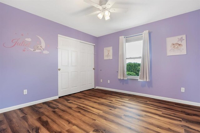 3912 Jacobs Lndg, Saint Charles, MO 63304 - unfurnished bedroom with baseboards, dark wood-style floors, ceiling fan, and a closet