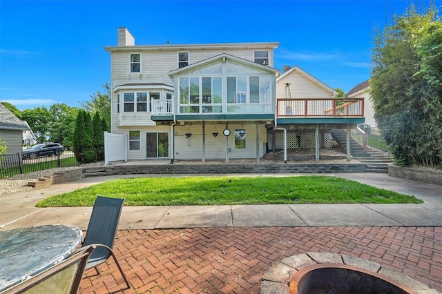 3912 Jacobs Lndg, Saint Charles, MO 63304 - back of house with a sunroom, stairway, a wooden deck, a chimney, and a patio area