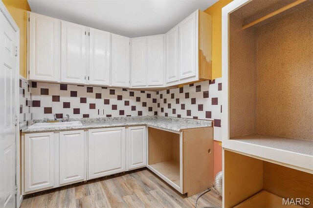 3912 Jacobs Lndg, Saint Charles, MO 63304 - kitchen with white cabinetry, light countertops, and light wood-style floors