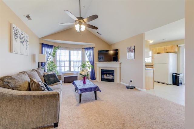 480 Benton Dr Unit L, Saint Peters, MO 63376 - living room featuring ceiling fan, light colored carpet, vaulted ceiling, a glass covered fireplace, and baseboards