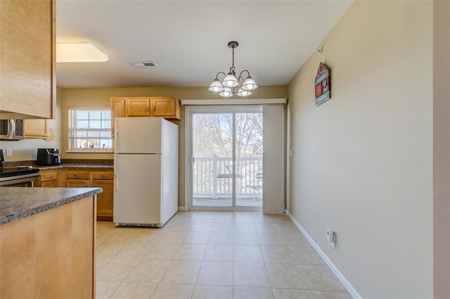 480 Benton Dr Unit L, Saint Peters, MO 63376 - kitchen featuring stainless steel appliances, dark countertops, a chandelier, decorative light fixtures, and light tile patterned floors