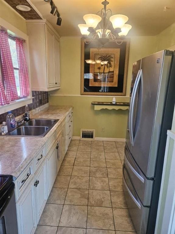 506 S Sparta St, Steeleville, IL 62288 - kitchen with freestanding refrigerator, white cabinetry, a chandelier, and light countertops