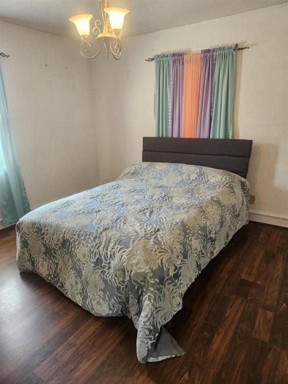 506 S Sparta St, Steeleville, IL 62288 - bedroom with wood finished floors, a chandelier, and baseboards