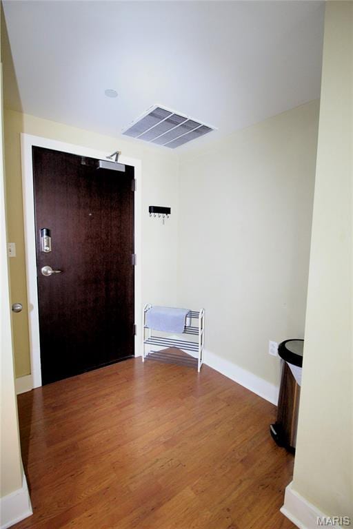 314 N Broadway Unit 603, Saint Louis, MO 63102 - spare room featuring wood finished floors and baseboards