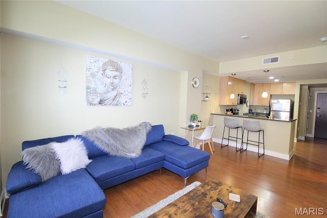 314 N Broadway Unit 603, Saint Louis, MO 63102 - living room featuring dark wood-style floors and baseboards