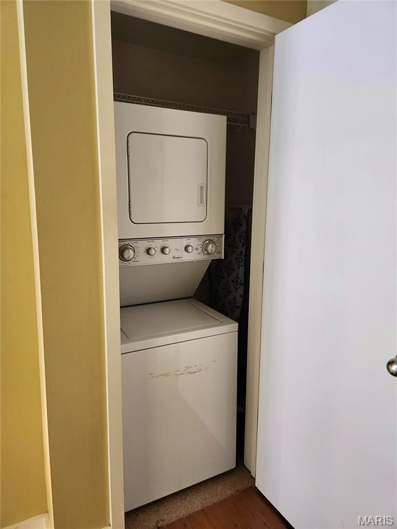 314 N Broadway Unit 603, Saint Louis, MO 63102 - laundry room featuring stacked washer / drying machine and dark wood-style floors