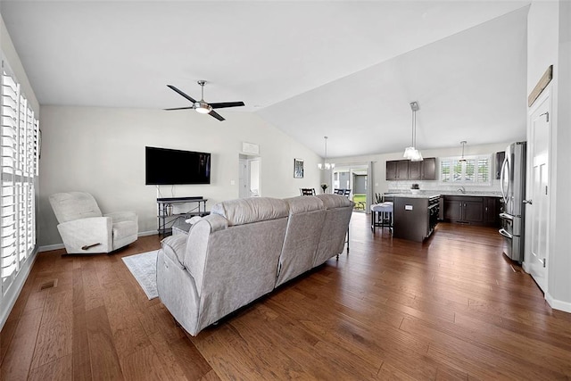 217 Arlington Dr, Moscow Mills, MO 63362 - living area with ceiling fan, vaulted ceiling, dark wood-type flooring, and baseboards