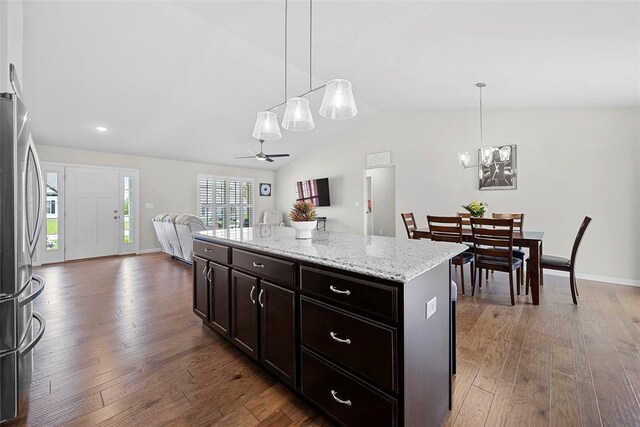 217 Arlington Dr, Moscow Mills, MO 63362 - kitchen featuring freestanding refrigerator, vaulted ceiling, open floor plan, a ceiling fan, and wood finished floors