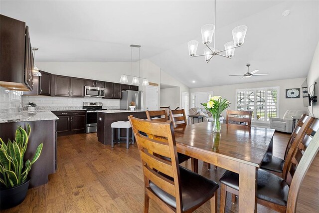 217 Arlington Dr, Moscow Mills, MO 63362 - dining space featuring lofted ceiling, a ceiling fan, dark wood-style floors, and a chandelier