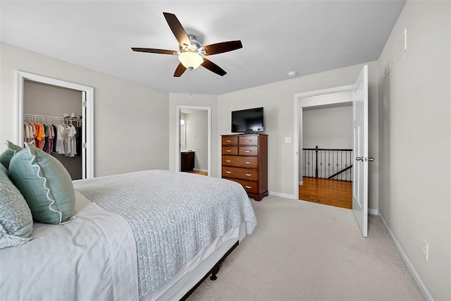 217 Arlington Dr, Moscow Mills, MO 63362 - carpeted bedroom with a spacious closet, a closet, baseboards, and a ceiling fan