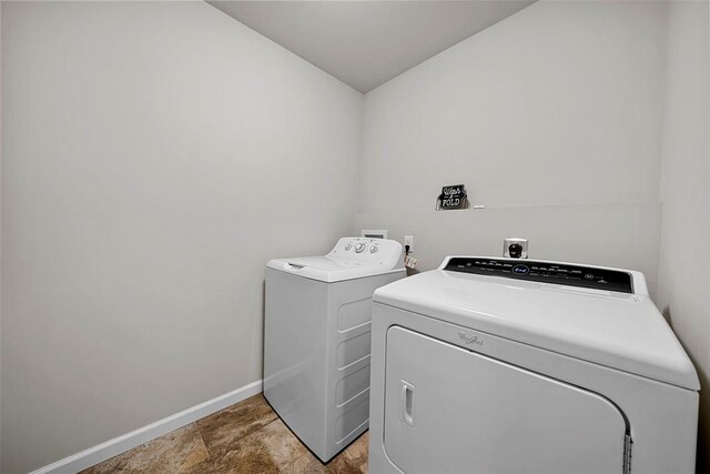 217 Arlington Dr, Moscow Mills, MO 63362 - laundry room featuring washing machine and clothes dryer and baseboards
