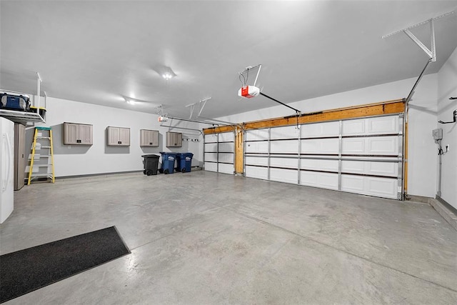 217 Arlington Dr, Moscow Mills, MO 63362 - garage featuring a garage door opener and baseboards