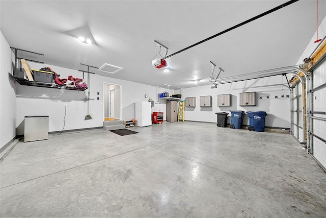 217 Arlington Dr, Moscow Mills, MO 63362 - garage with a garage door opener and baseboards
