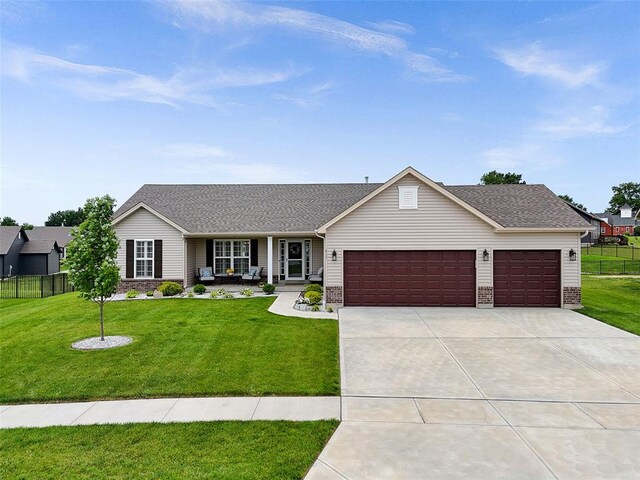 217 Arlington Dr, Moscow Mills, MO 63362 - ranch-style home with an attached garage, driveway, a porch, roof with shingles, and brick siding