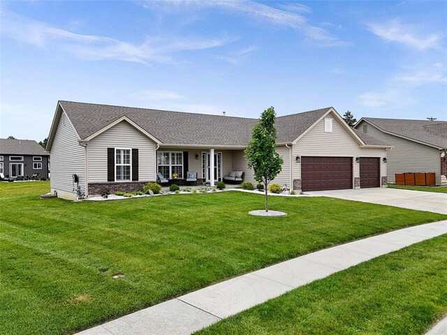 217 Arlington Dr, Moscow Mills, MO 63362 - ranch-style home with an attached garage, brick siding, driveway, and a front yard