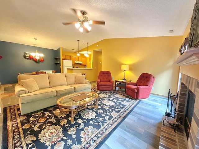 18318 Lakeview Cir Unit 606, Monroe City, MO 63456 - living area with ceiling fan, lofted ceiling, wood finished floors, a brick fireplace, and baseboards