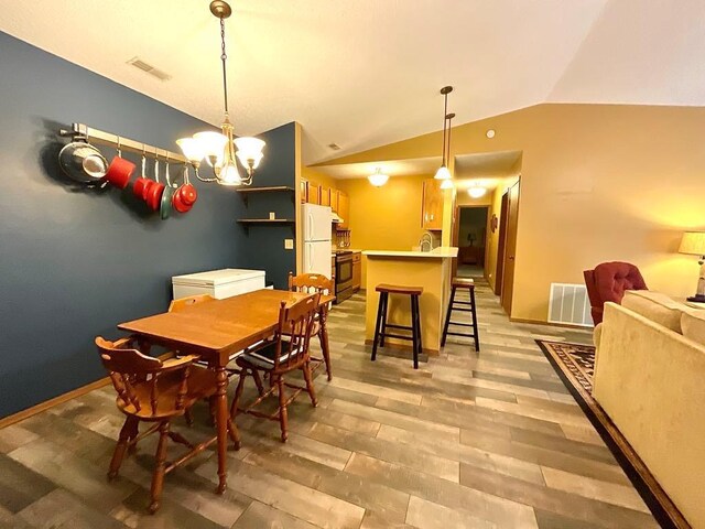 18318 Lakeview Cir Unit 606, Monroe City, MO 63456 - dining room featuring light wood-style flooring, lofted ceiling, and a chandelier