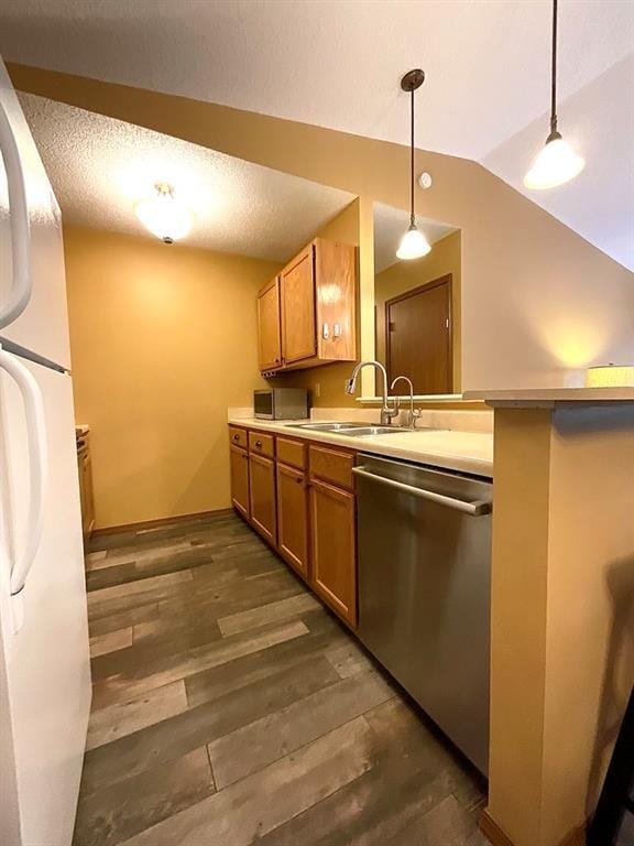 18318 Lakeview Cir Unit 606, Monroe City, MO 63456 - kitchen featuring stainless steel appliances, a sink, brown cabinetry, pendant lighting, and light countertops