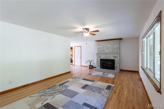 811 Bray Ave, Rolla, MO 65401 - unfurnished living room featuring a ceiling fan, wood finished floors, baseboards, and a large fireplace