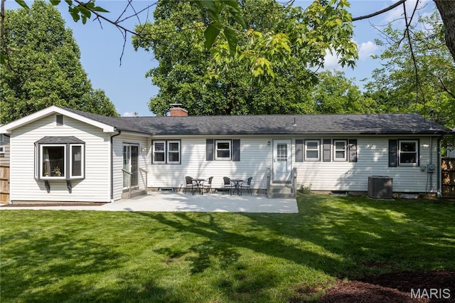 811 Bray Ave, Rolla, MO 65401 - back of property with entry steps, a chimney, central air condition unit, and a patio area