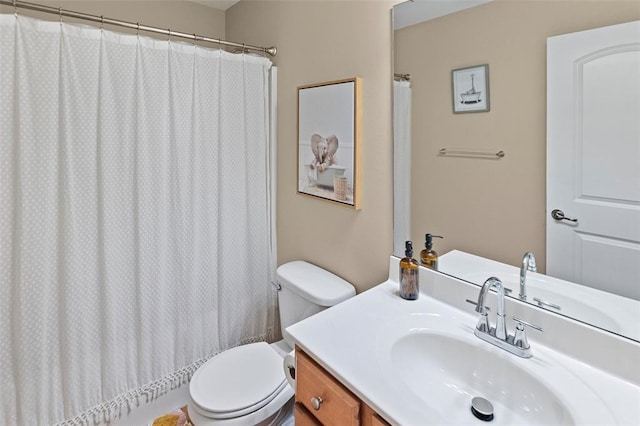 bathroom featuring toilet, vanity, and a shower with curtain