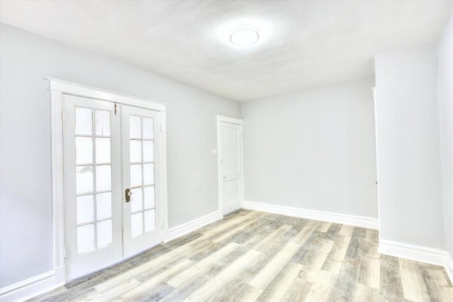5027 S Broadway Ave Unit 1-4, Saint Louis, MO 63111 - spare room featuring french doors, wood finished floors, and baseboards