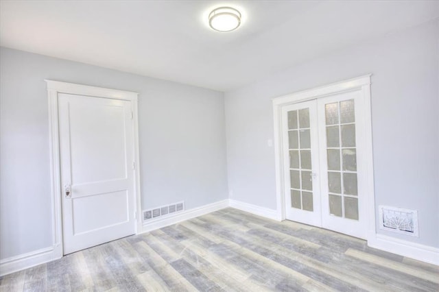 5027 S Broadway Ave Unit 1-4, Saint Louis, MO 63111 - spare room featuring wood finished floors, baseboards, and french doors