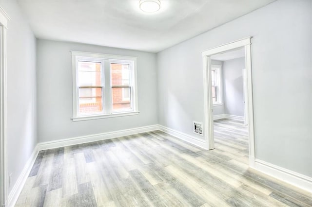 5027 S Broadway Ave Unit 1-4, Saint Louis, MO 63111 - spare room with wood finished floors, plenty of natural light, and baseboards