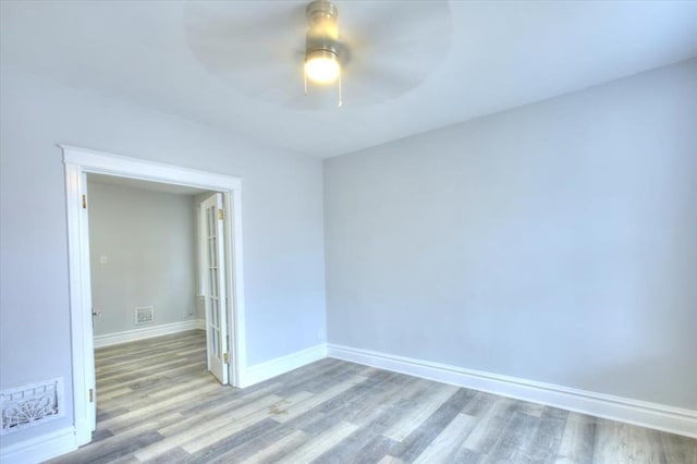 5027 S Broadway Ave Unit 1-4, Saint Louis, MO 63111 - empty room with wood finished floors, ceiling fan, and baseboards