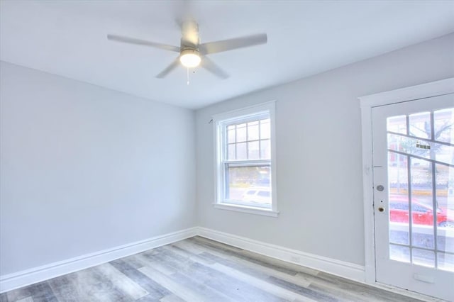 5027 S Broadway Ave Unit 1-4, Saint Louis, MO 63111 - empty room with wood finished floors, ceiling fan, and baseboards