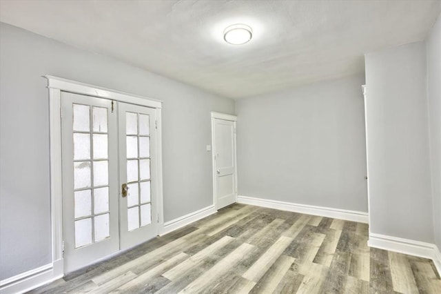 5027 S Broadway Ave Unit 1-4, Saint Louis, MO 63111 - spare room featuring french doors, wood finished floors, and baseboards